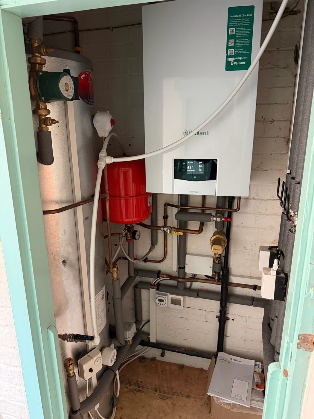 Boiler and cylinder installed inside a domestic airing cupboard