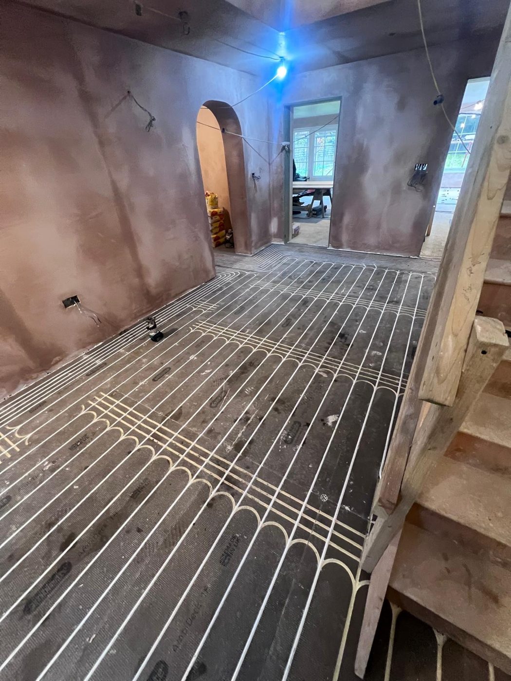 Room with underfloor heating pipework laid across the full floor area