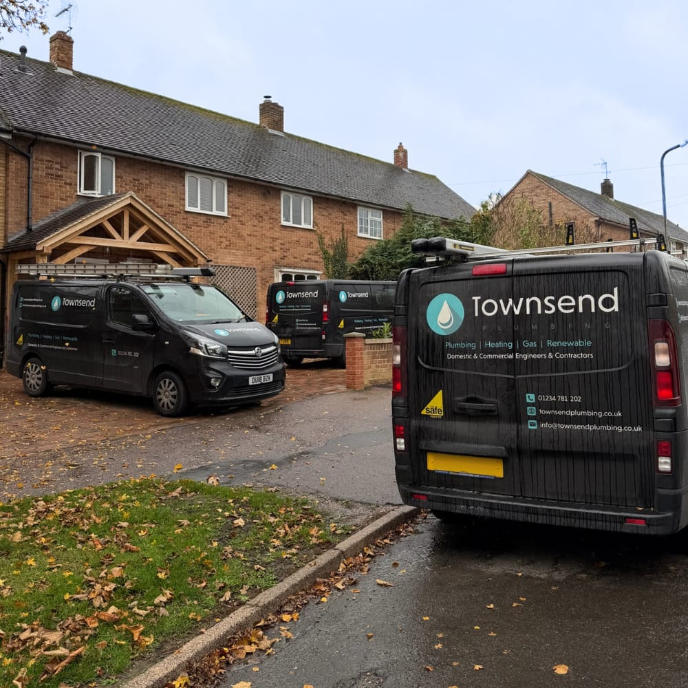 Townsend Plumbing vans parked outside a house on a job in Bedfordshire
