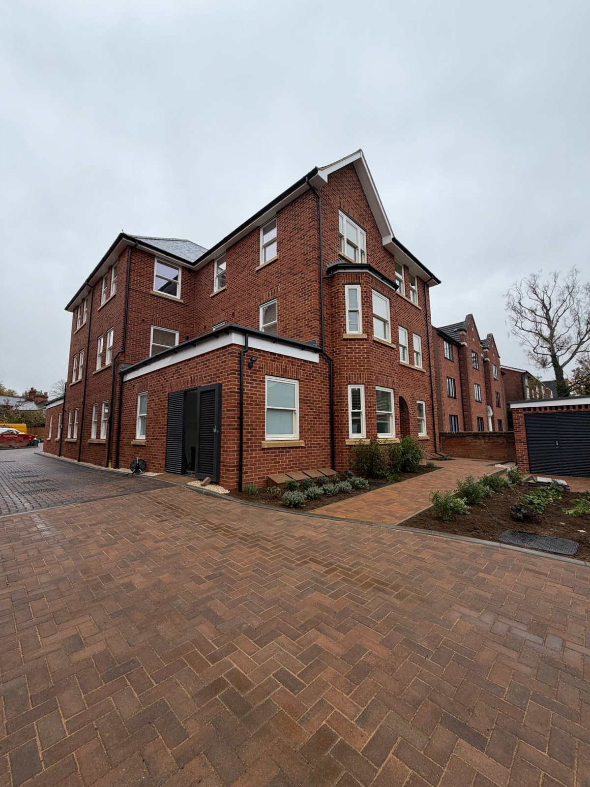Completed new-build apartment block in central Bedford with block-paved courtyard