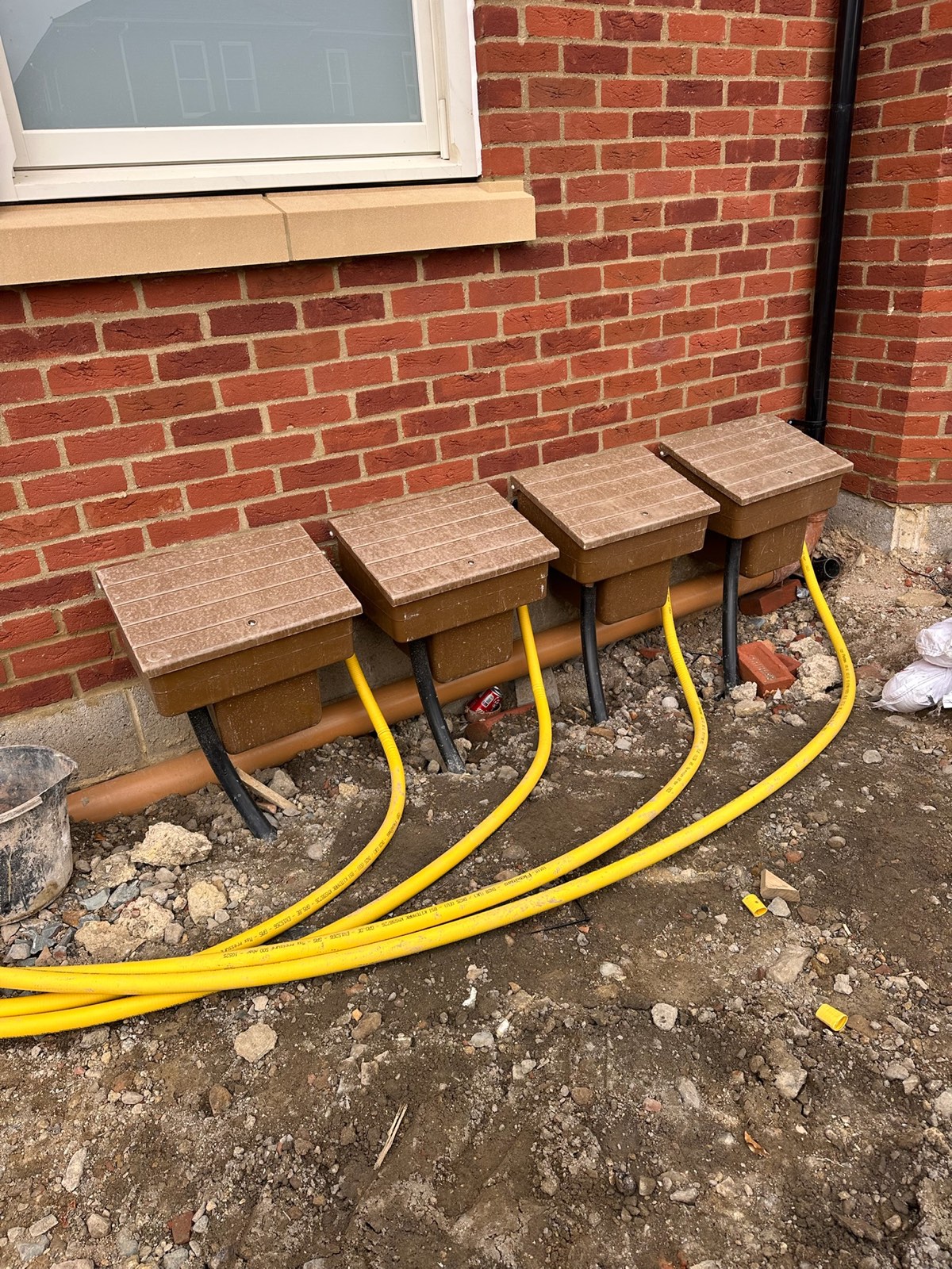 First-fix boiler pipework with isolation valves and circulating pump in an apartment