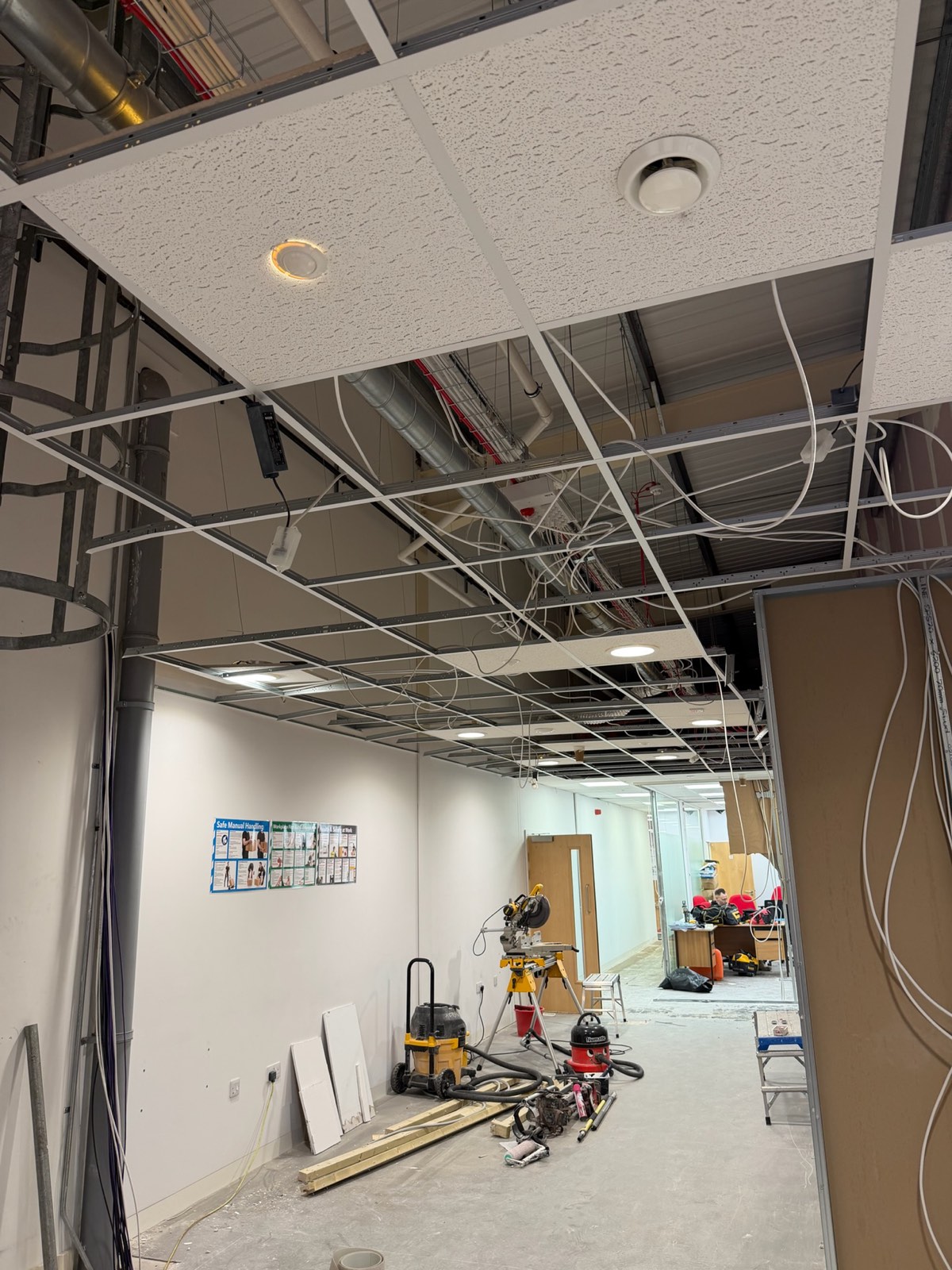Workshop reconfiguration with suspended ceiling grid and first-fix services overhead