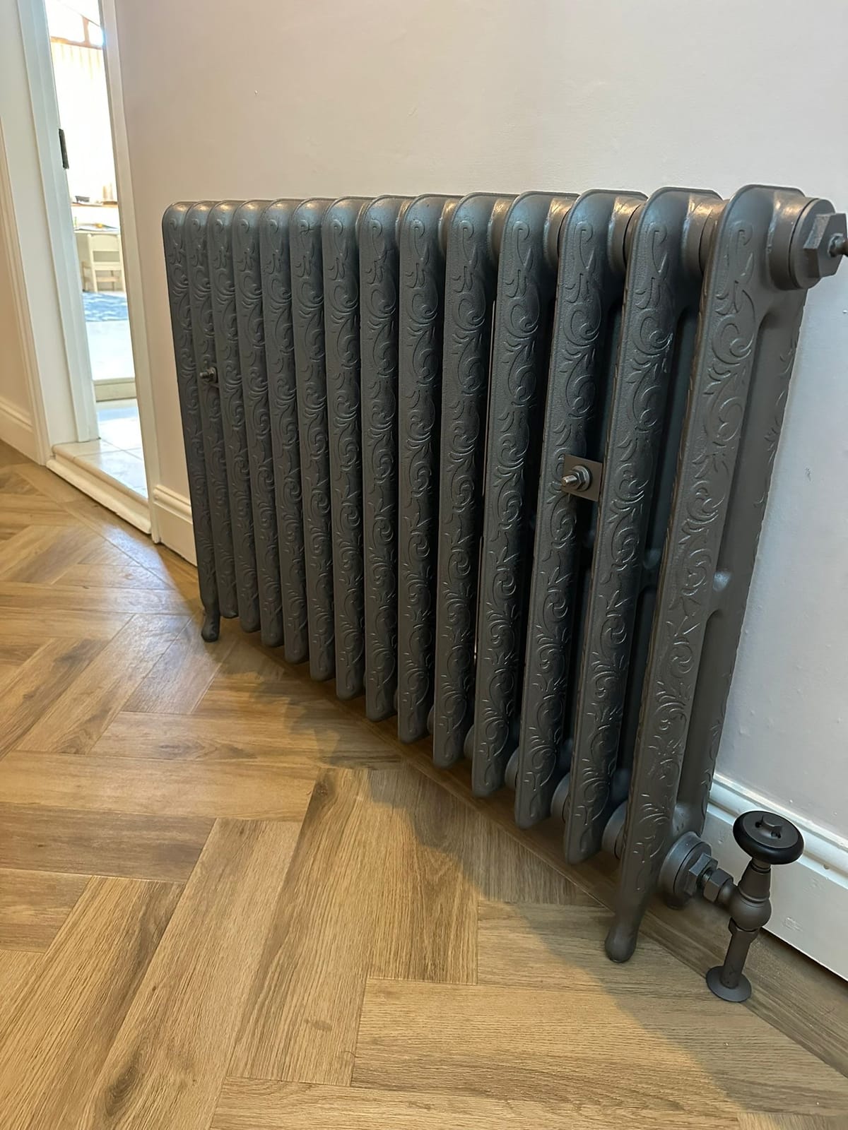 Restored ornate cast iron radiator fitted during a period property refurbishment