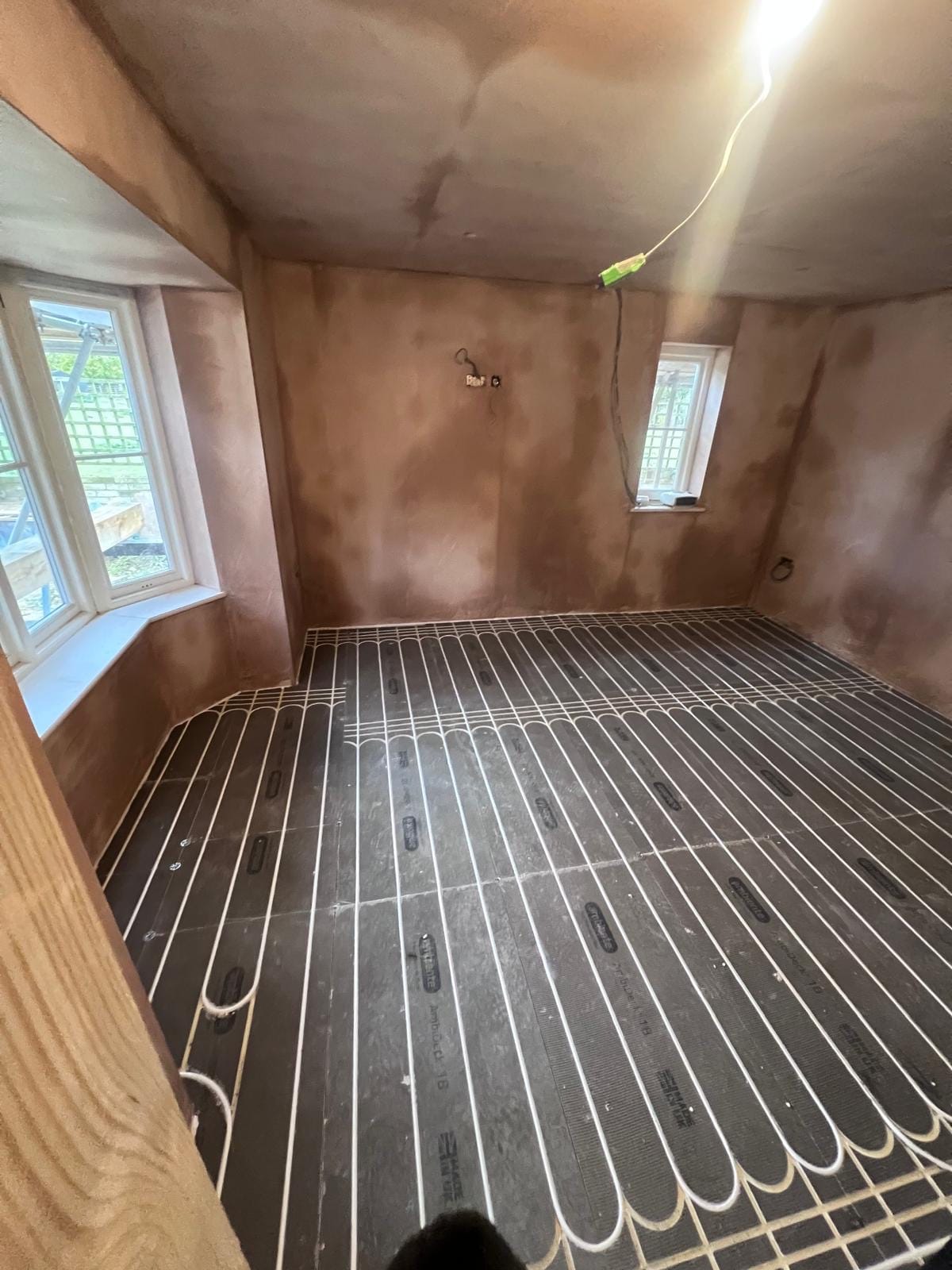 Underfloor heating pipework run across a full ground floor during a renovation