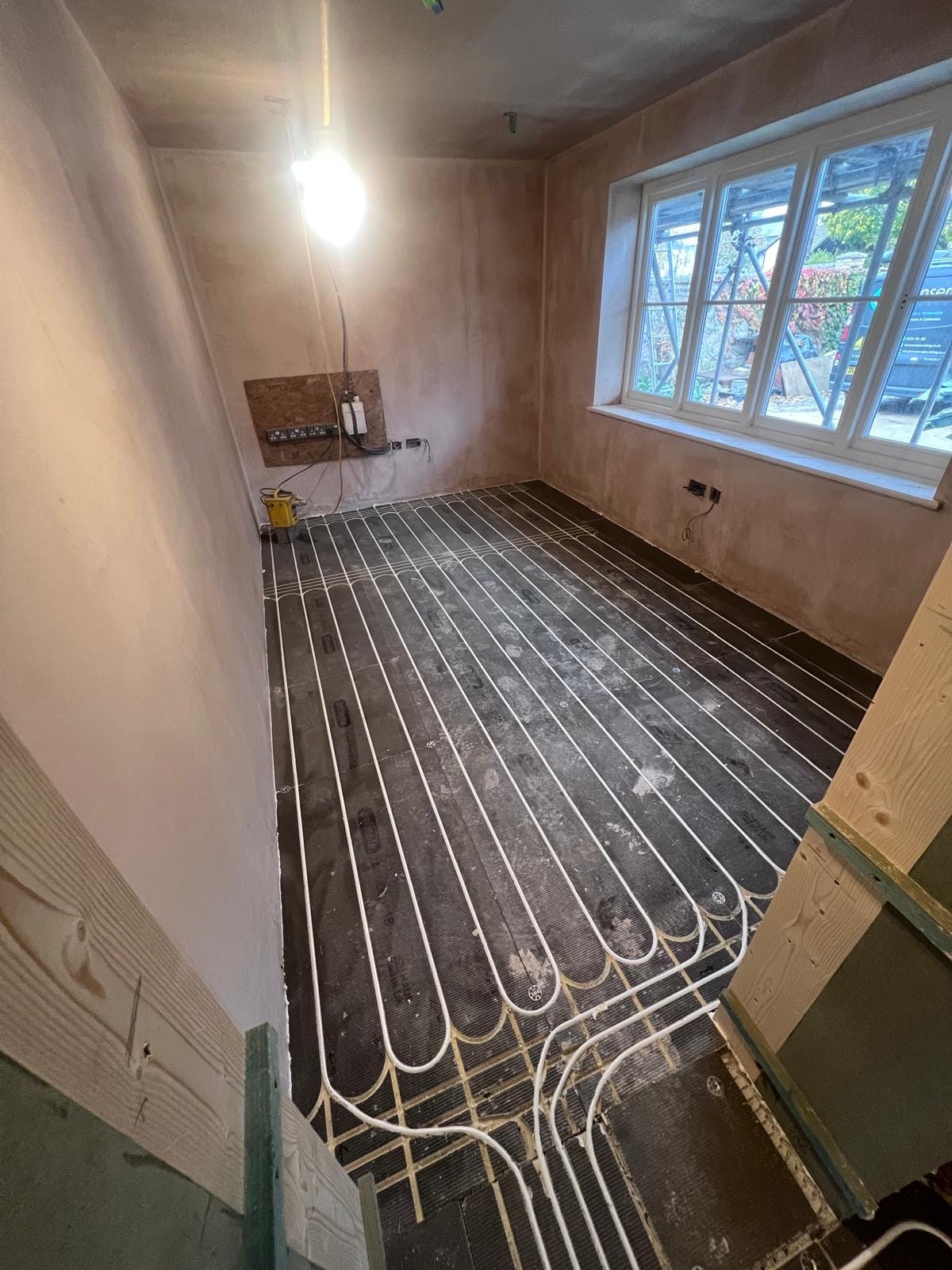 Wet underfloor heating loops laid out ready for screed